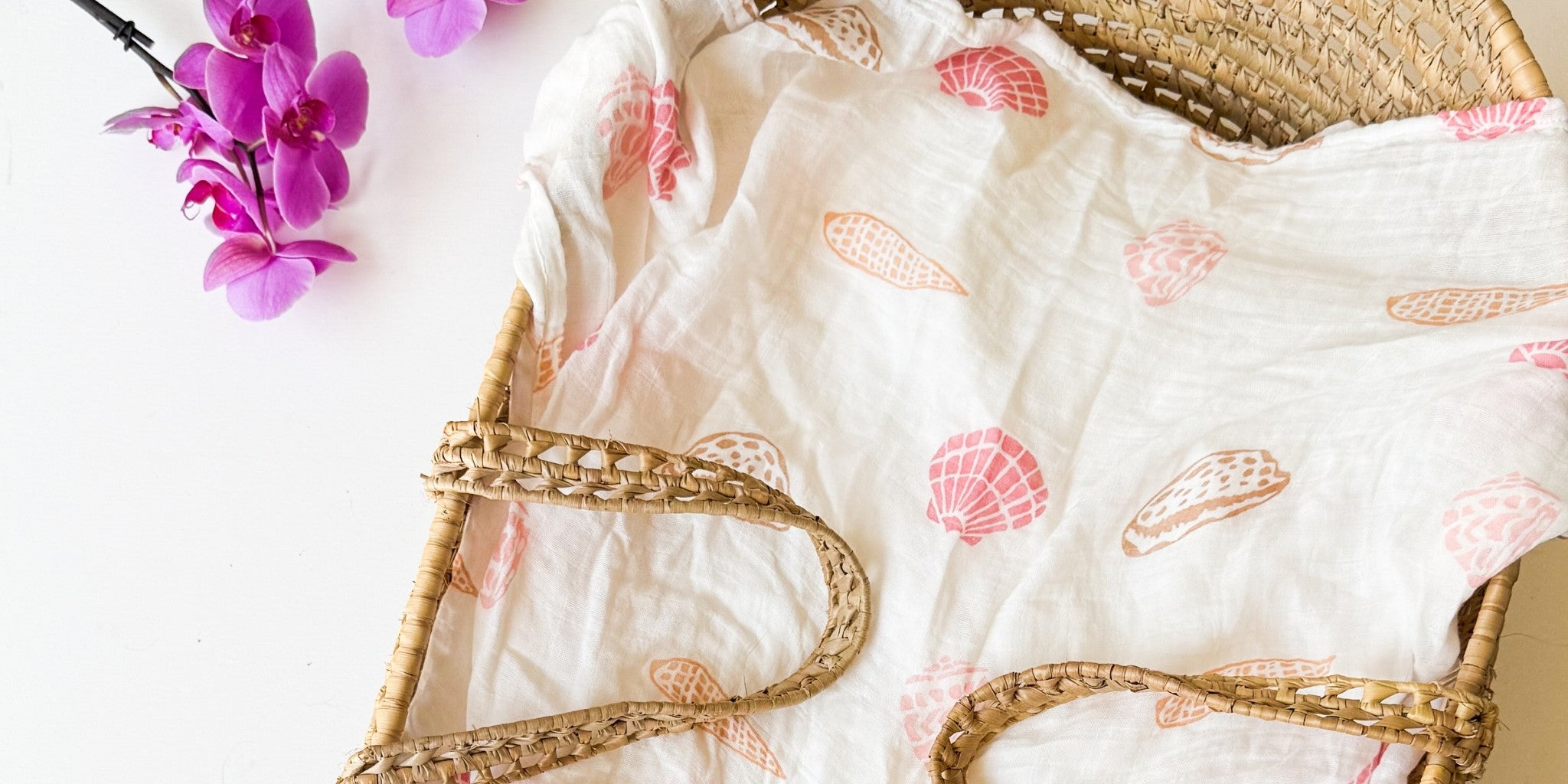 seashell print organic baby swaddle in earth tones, pink, beije, mauve, sand, terracotta