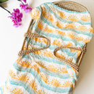 sun and wave surfer baby swaddle in blue yellow and aqua